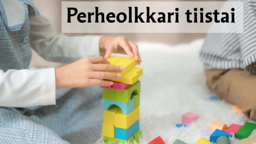 Lapsi rakentaa värikkäistä palikoista tornin.